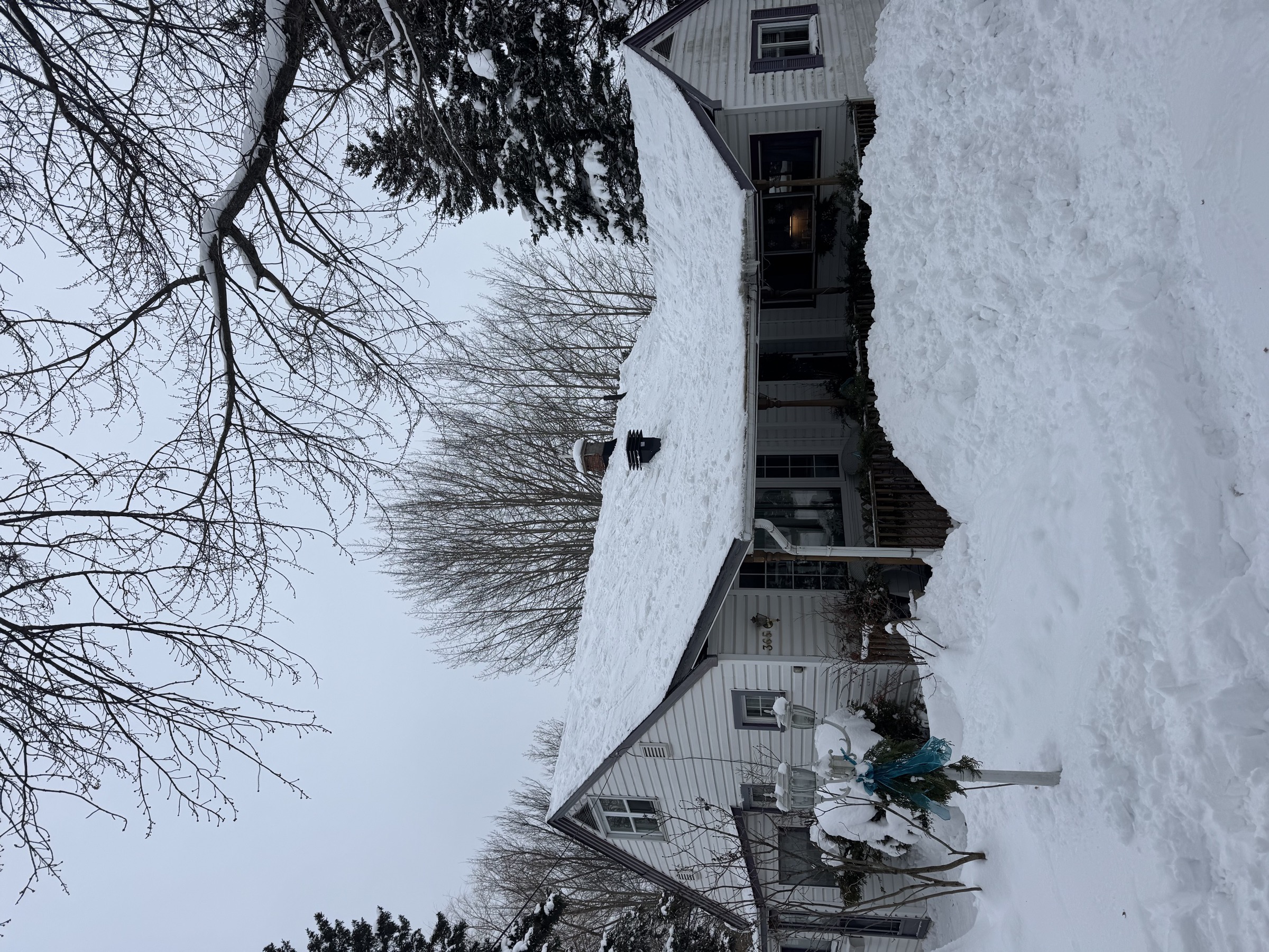 A Sault Ste. Marie home under heavy roof snow load before clearing