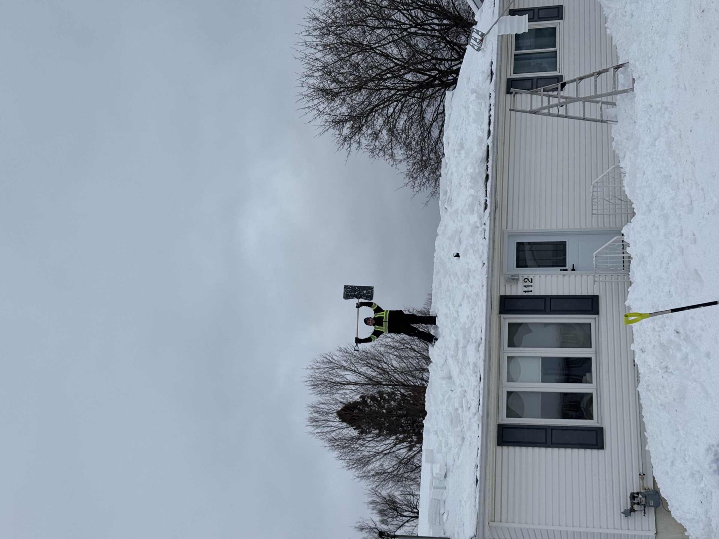 Roofline crew member standing on a fully cleared bungalow roof